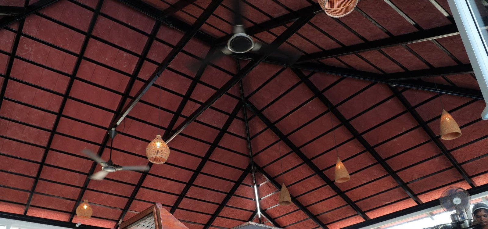 Terracotta ceiling with rattan lamps