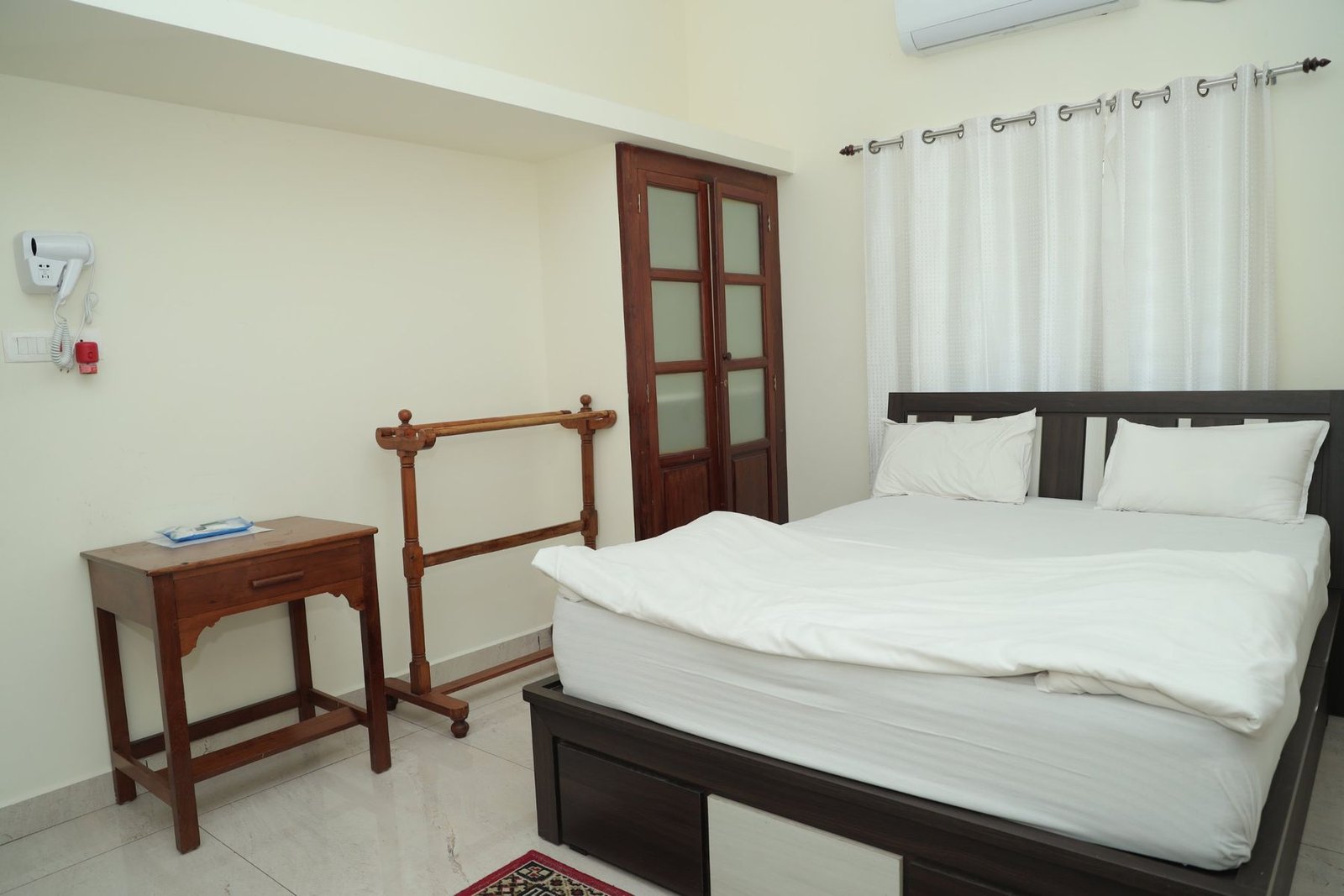 Room with writing table and towel rail